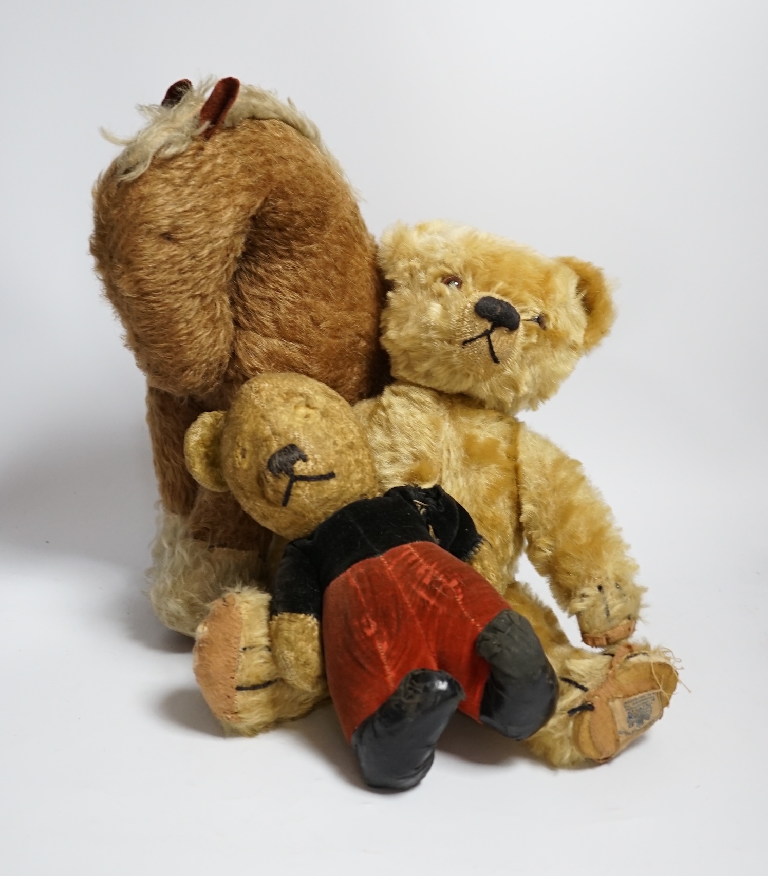 A Chad Valley teddy bear, 34cm high, a smaller bear in velvet clothes and a Merrythought horse